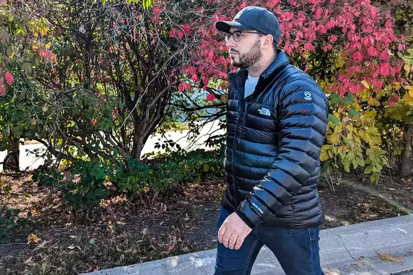 A person walks outside while wearing the North Face Men’s Summit Series Breithorn Jacket