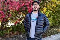 A person wears The North Face Men’s Summit Series Breithorn Jacket while walking outside