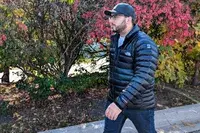 A person walks outside while wearing the North Face Men’s Summit Series Breithorn Jacket