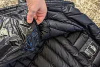 A person holds the pocket of The North Face Men’s Summit Series Breithorn Jacket