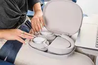 A person opening the Bowers & Wilkins Px7 S2e carrying case on their lap