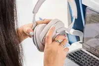 A person opening the Bowers & Wilkins Px7 S2e over a laptop