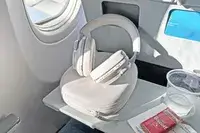 Bowers & Wilkins px6 s2e Headphones on an airplane tray table