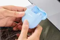 Two hands holding an opened Bose QuietComfort Ultra Earbuds case