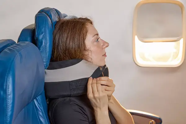 A person adjusting the Cabeau The Neck