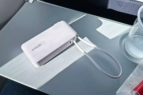 Anker Nano 3-in-1 Portable Charger on an airplane tray table