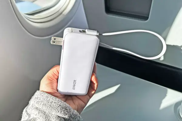 Person holding Anker Nano 3-in-1 Portable Charger on an airplane