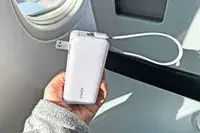 Person holding Anker Nano 3-in-1 Portable Charger on an airplane