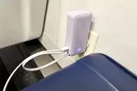 The Anker Nano 3-in-1 Portable Power Bank plugged into a wall outlet