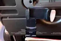 The Perilogics Universal In-flight Plane Holder Mount in the tray table of a planae