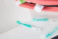 The Freshee 5-in-1 Disposable Mini Toothbrush on a bathroom counter