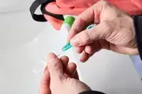 A person attaching the floss tip to the Freshee 5-in-1 Disposable Mini Toothbrush