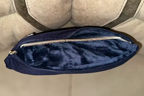 Travelrest 4-in-1 Travel Blanket carrying pouch displayed unzipped on a gray surface