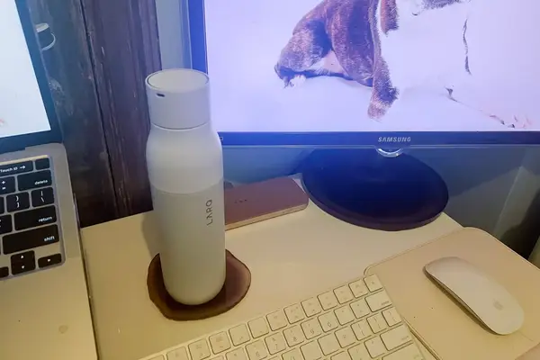 A Larq Bottle PureVis next to a computer screen and keyboard