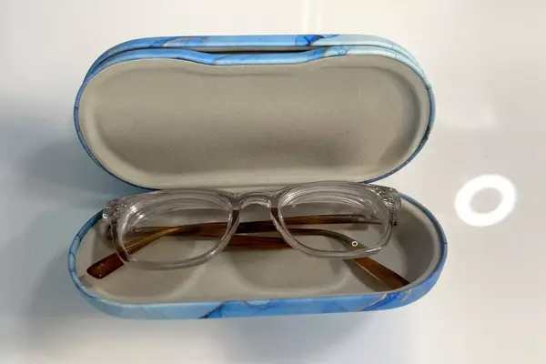 A pair of glasses in the Zettokete 2-in-1 Contact Lens and Glasses Case