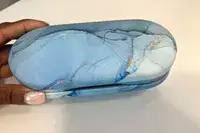 A person holding the Zettokete 2-in-1 Contact Lens and Glasses Case