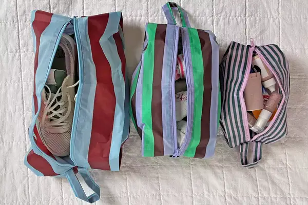 The Baggu 3D Zip Set sitting side-by-side on a white blanket