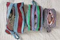 The Baggu 3D Zip Set sitting side-by-side on a white blanket