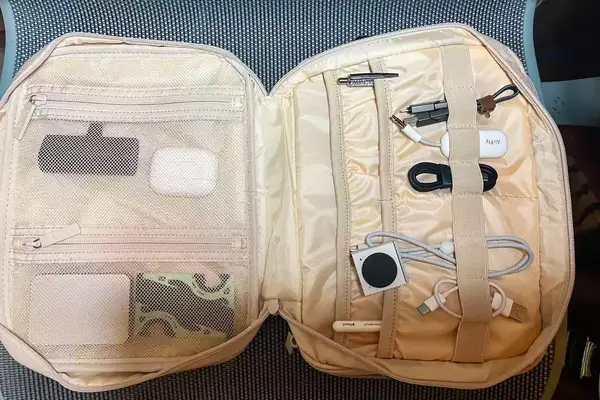 Calpak Tablet Tech Organizer Open And Displaying Various Cables and Chargers