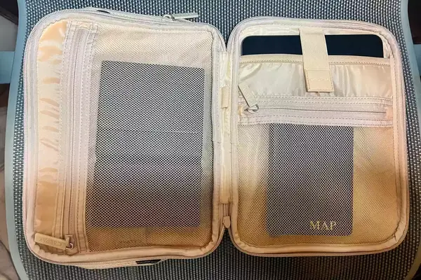 Calpak Tablet Tech Organizer Open And Displaying Personal Items