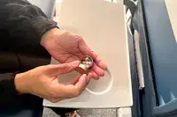 A person opening the PPFISH Portable Daily Pill Case