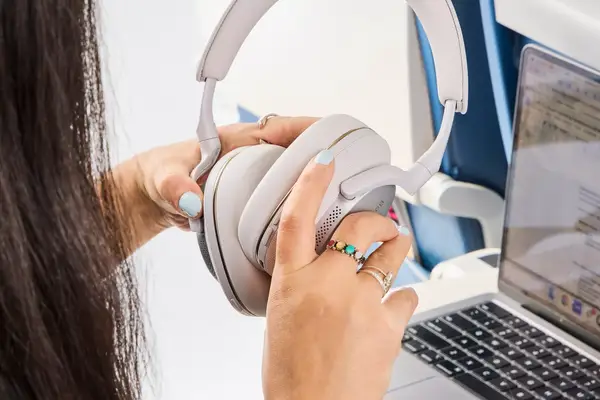 A person opening the Bowers & Wilkins Px7 S2e over a laptop