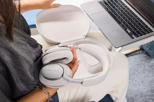A person removing the Bowers & Wilkins Px7 S2e from the carrying case