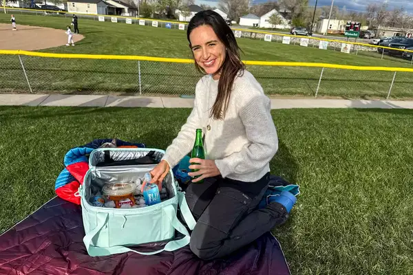 A person removes items from the RTIC 6-Can Everyday Cooler