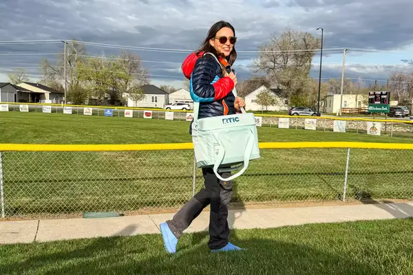 A person carries the RTIC 6-Can Everyday Cooler by the shoulder strap