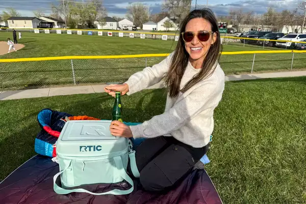 A person removes a drink from the RTIC 6-Can Everyday Cooler