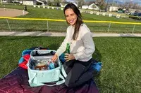 A person removes items from the RTIC 6-Can Everyday Cooler