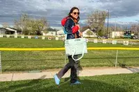 A person carries the RTIC 6-Can Everyday Cooler by the shoulder strap