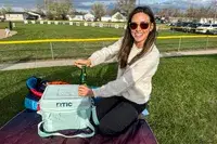 A person removes a drink from the RTIC 6-Can Everyday Cooler