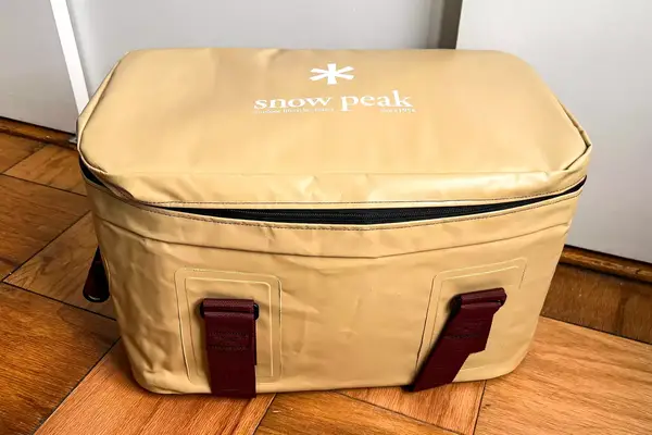 The Snow Peak Soft Cooler 38 on a wooden floor
