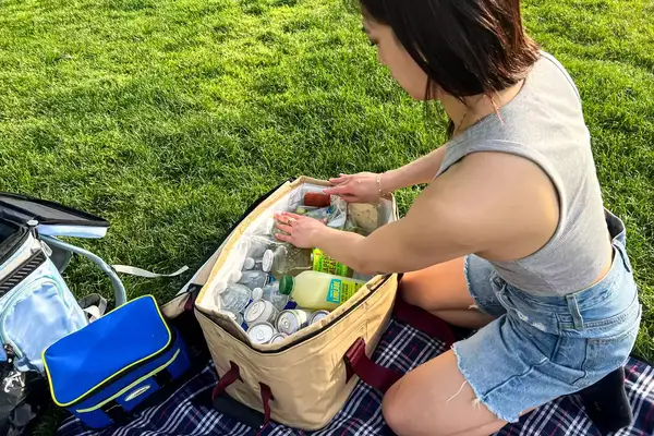 A person unpacks the Snow Peak Soft Cooler 38