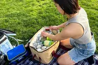 A person unpacks the Snow Peak Soft Cooler 38