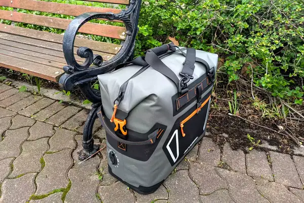 The Engel HD30 Heavy-Duty Soft-Sided Cooler Bag next to a park bench
