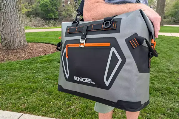A person carries the Engel HD30 Heavy-Duty Soft-Sided Cooler Bag by the top handle