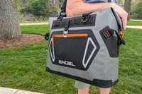 A person carries the Engel HD30 Heavy-Duty Soft-Sided Cooler Bag by the top handle
