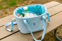 The Hydro Flask 20L Carry Out Soft Cooler Travel Bag filled with ice and snacks