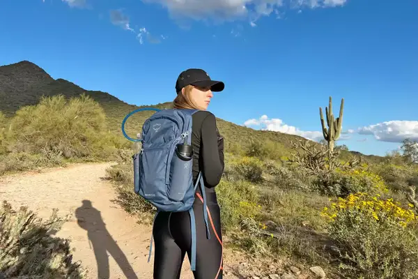 Woman wearing an Osprey Daylite Plus Daypack on a desert trail