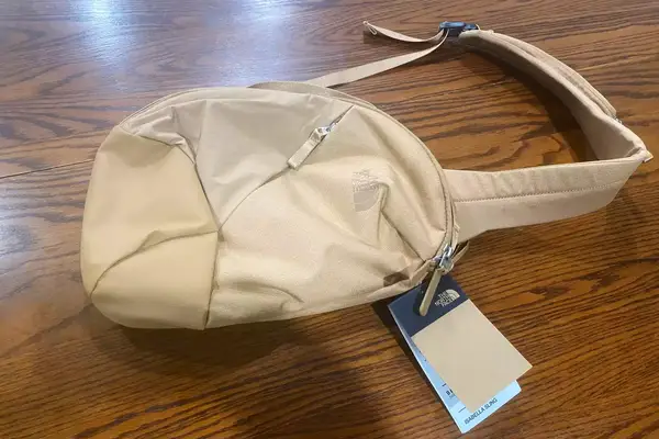 The North Face Women’s Isabella Sling on wood background with tags attached