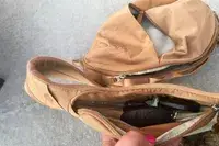 Hand opens pocket to display keys inside The North Face Women’s Isabella Sling