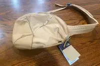 The North Face Women’s Isabella Sling on wood background with tags attached