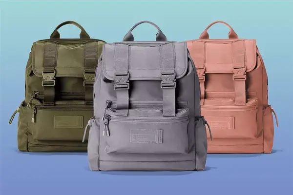 Dagne Dover Brooklyn Backpack in Dark Moss, Ash and Warm Dust on a blue background