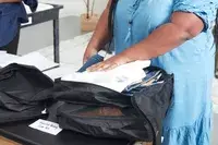 A packed Patagonia Black Hole Cube, Large 14L on a couch