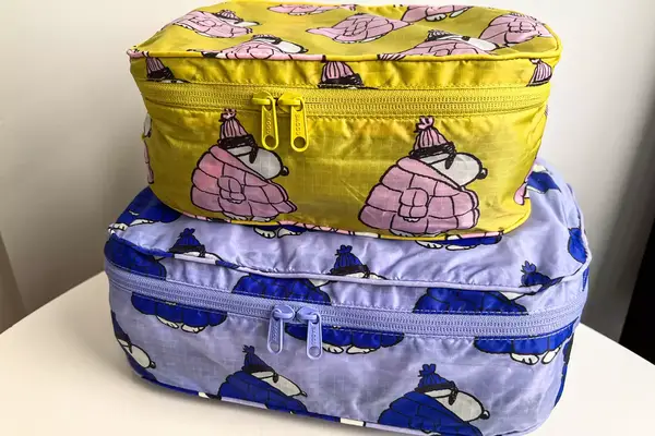 A filled Baggu Packing Cube Set on a white table