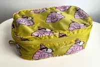 A closed piece of the Baggu Packing Cube Set on a white table