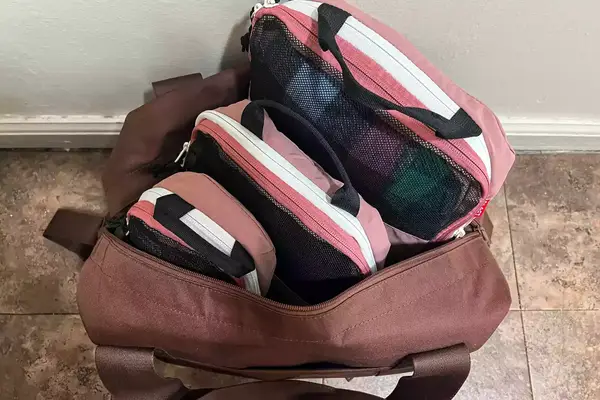 Three pieces of the Blast 6PCS Compression Travel Packing Cubes in a bag on a tile floor