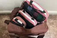 Three pieces of the Blast 6PCS Compression Travel Packing Cubes in a bag on a tile floor